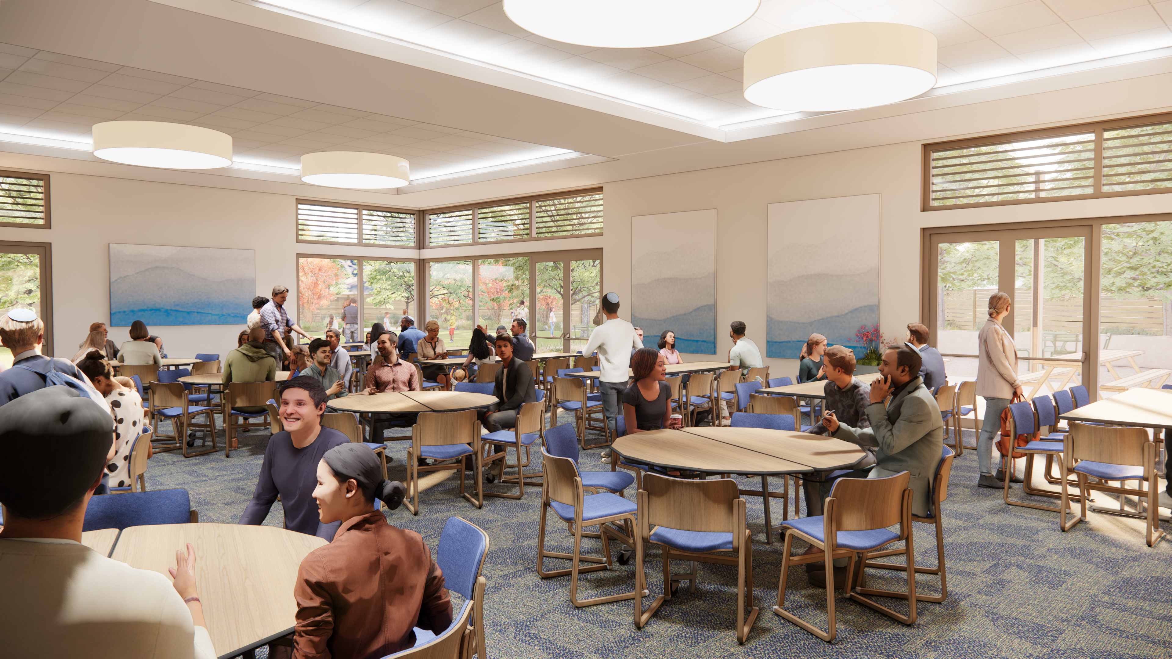 Social hall with round tables for community gathering and mountain artwork